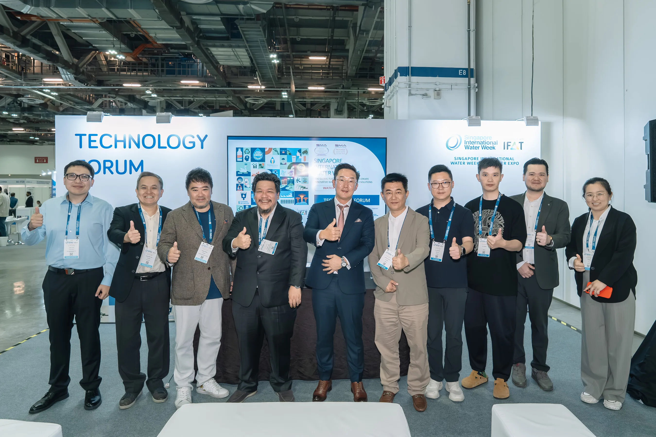 Ten attendees pose with thumbs up at the Singapore International Water Week Technology Forum.