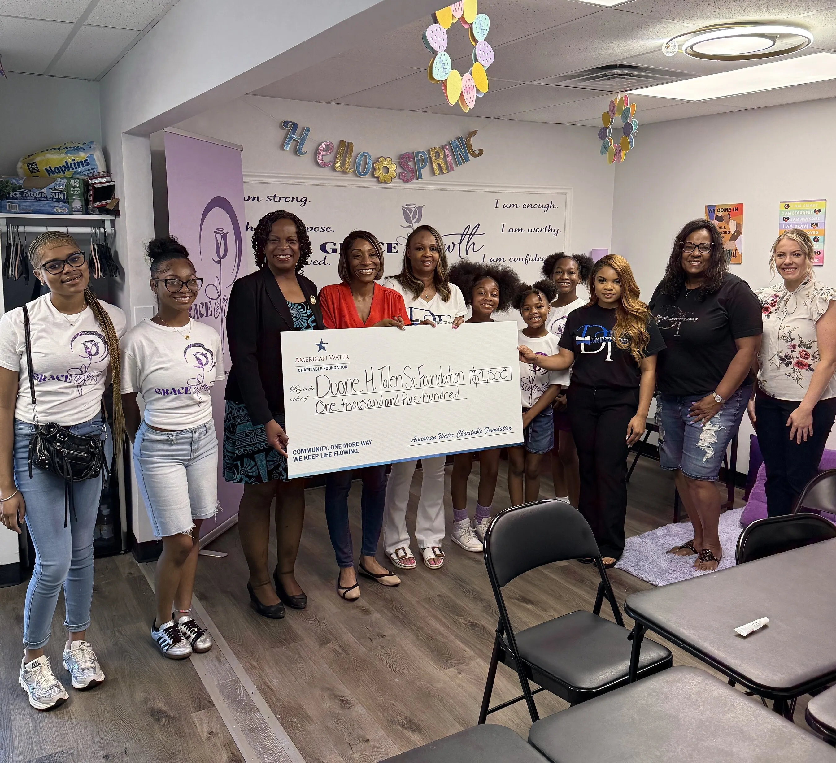 People holding a $1,500 American Water Charitable Foundation check made out to the Duane H. Tolen Sr. Foundation.