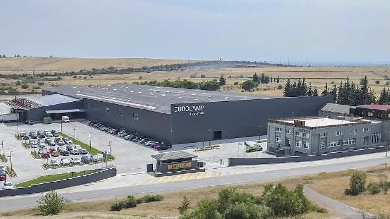 EUROLAMP logistics and distribution center with a parking lot and a second building beside open fields.