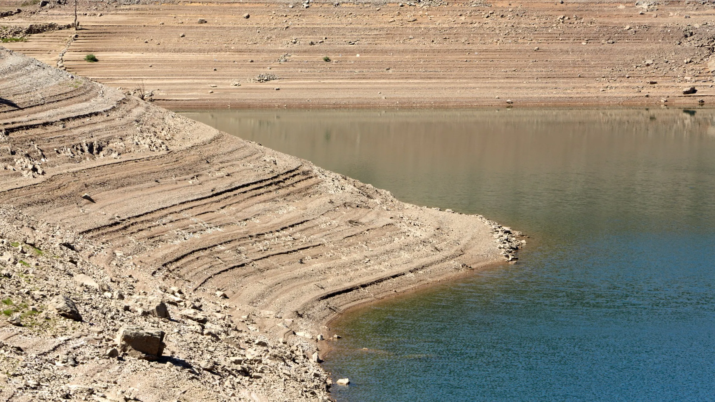 Bare, stepped banks of a reservoir with its water level far below normal
