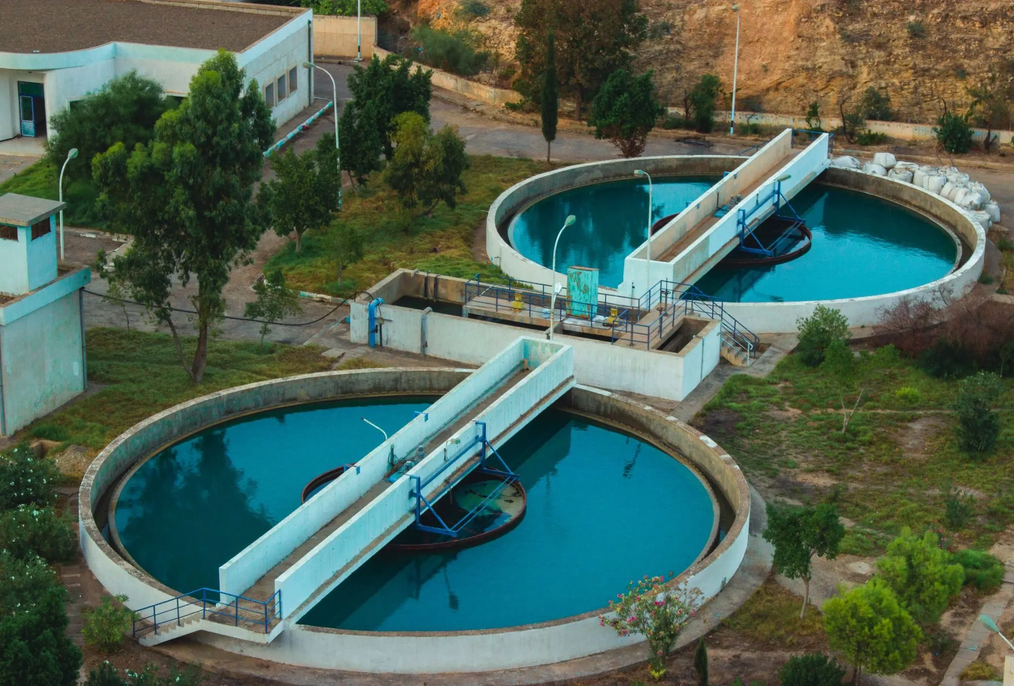 The round settling tanks of a water treatment works, seen from above